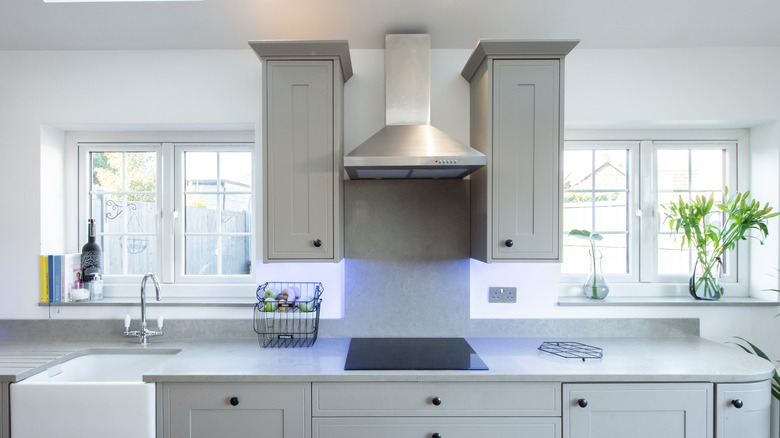 A kitchen with a stainless steel range hood