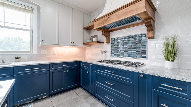 A kitchen with blue and white cabinets