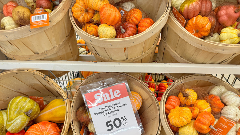Decorative pumpkins are on display at Michaels with a fifty percent off tag.