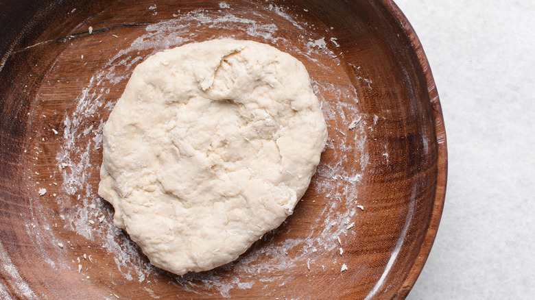 dough ball in a wooden bowl