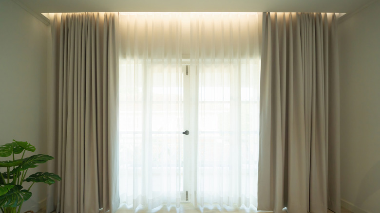light filters through layered curtains for a luxurious and comforting room