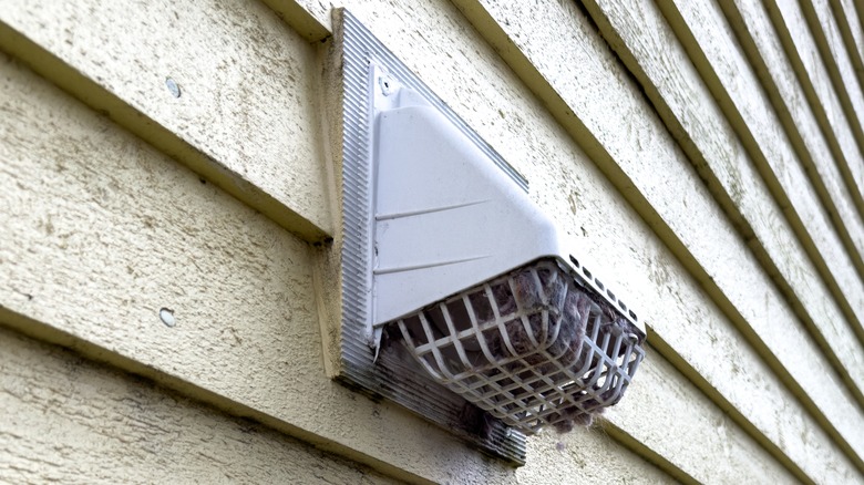 Dryer vent on a the outside of a house.