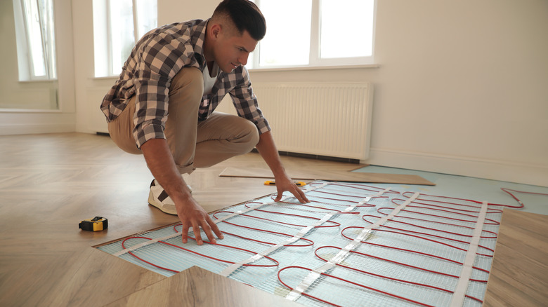 Person installing in-floor heating