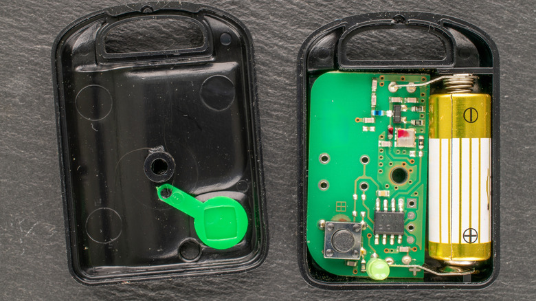 An unscrewed garage door remote showing internal components