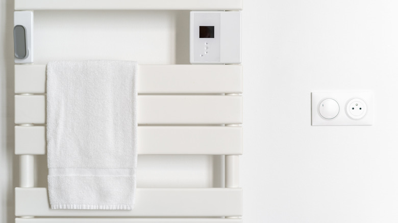 White towel hanging on a heated towel rack