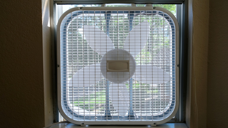 Box fan placed in a window to increase circulation