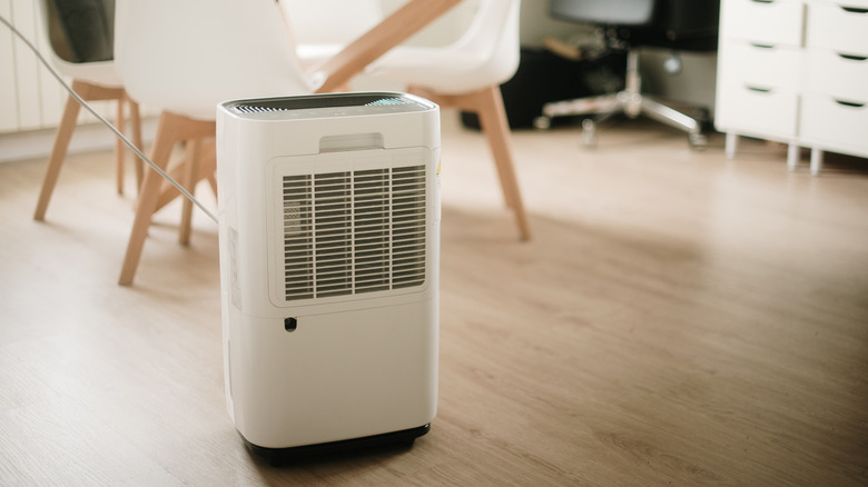 White dehumidifier running in a dining room