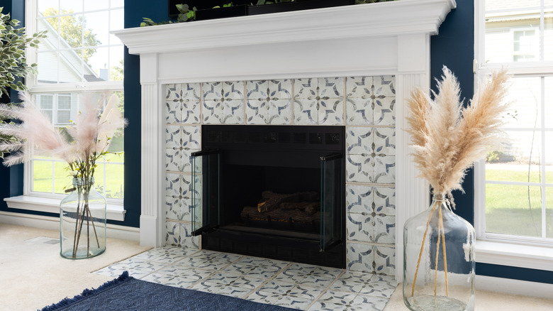 An updated fireplace with tile on the surround
