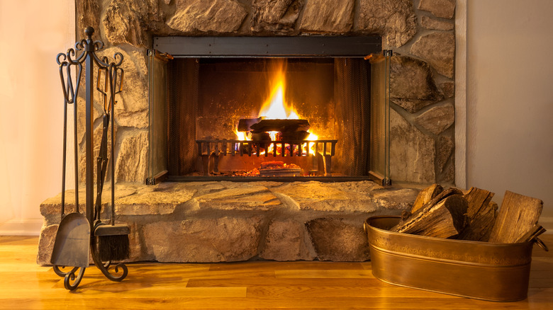 Fireplace with a log holder and a set of fireplace tools