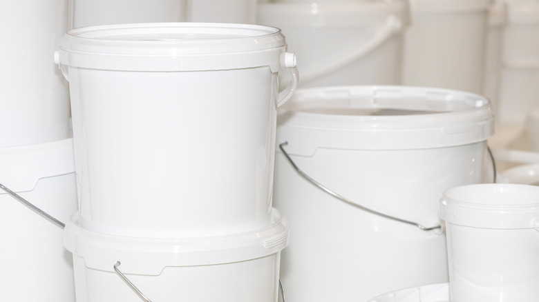 Stack of white food grade buckets