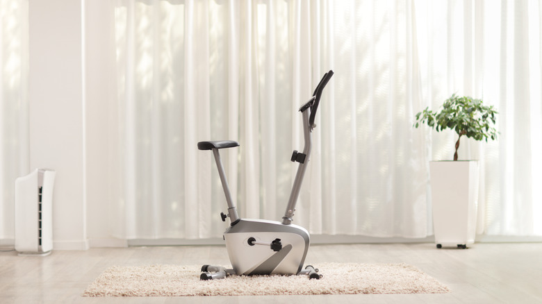 Indoor exercise bike in front of a white curtain