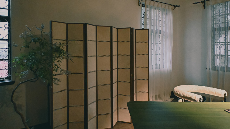 A wood room divider in a living room