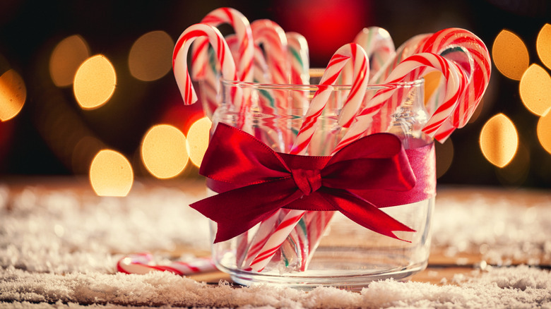 Jar of candy canes sitting on a table