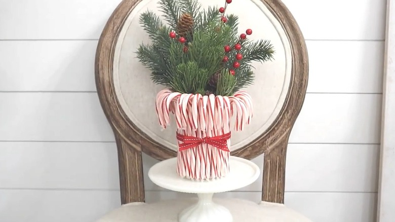 Christmas arrangement in a DIY vase made from a tin can with candy canes glued around it