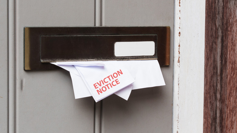 An eviction notice sticking out of a mail slot