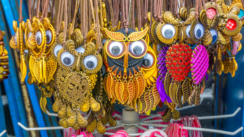 Large display of owl necklaces