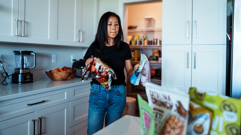 Woman placing items from pantry onto the coutner