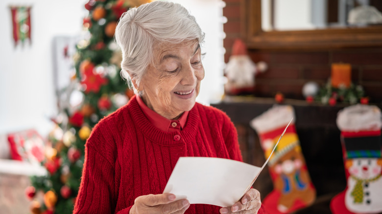 Older woman reading Christmas card