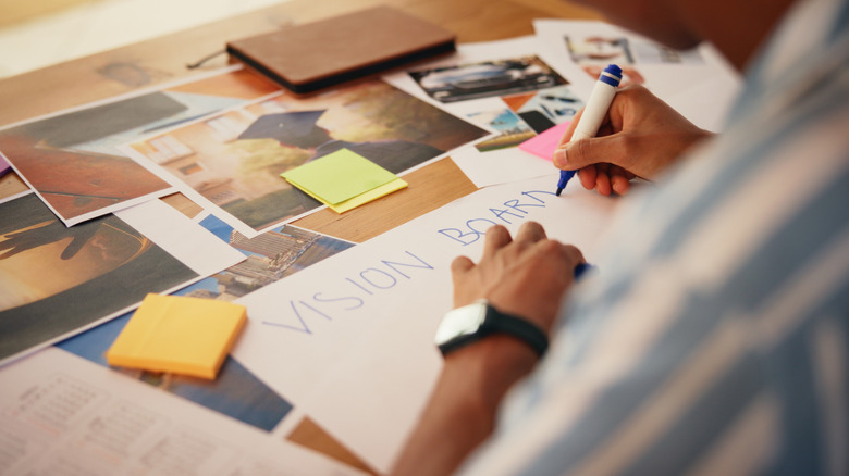 Hands creating a vision board