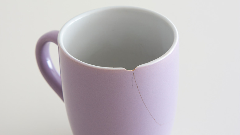 A chipped light purple coffee mug