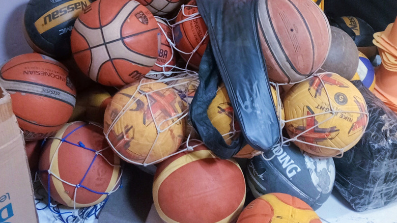 Old basketballs piled up in a corner