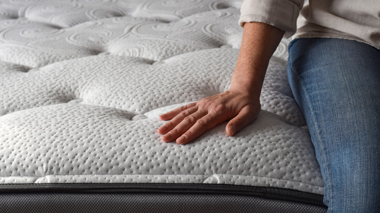 Hand testing a mattress