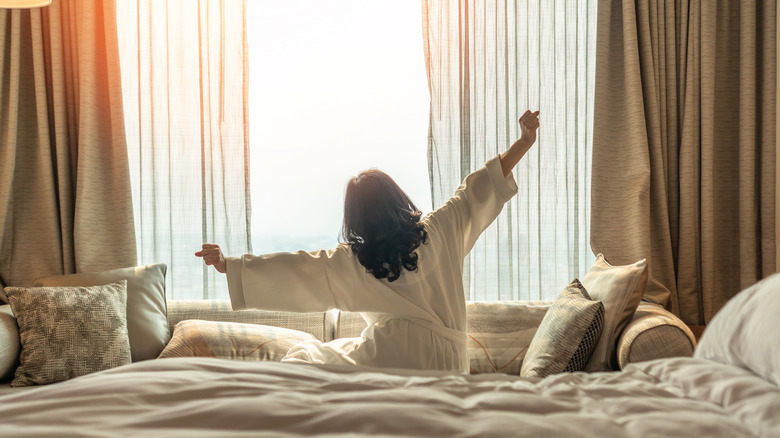 Woman stretching in bed