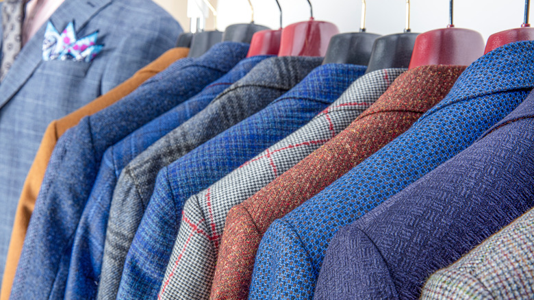 Rows of men's jackets on hangers