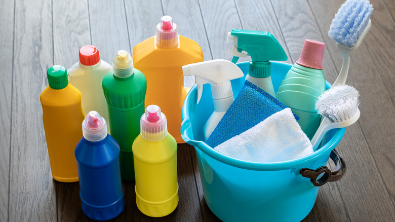 Close up of multiple cleaning supply bottles and tools