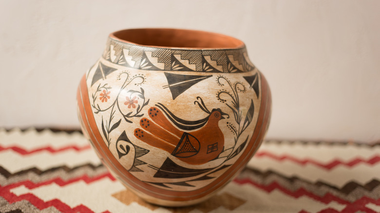 An antique pueblo vase on a rug