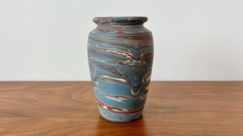 A vintage blue and brown swirled Niloak vase on a table