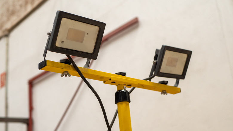 Two work lights mounted on a yellow metal frame