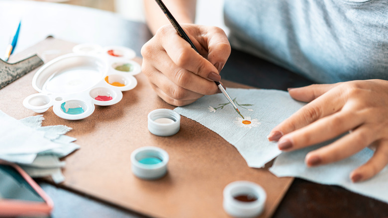 Painting flowers on fabric