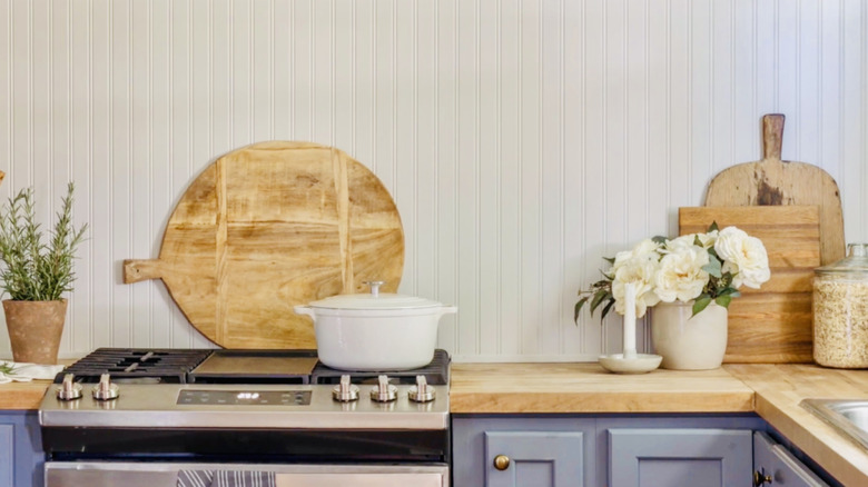 A beadboard backsplash and simple wood countertop add cottage charm to this kitchen