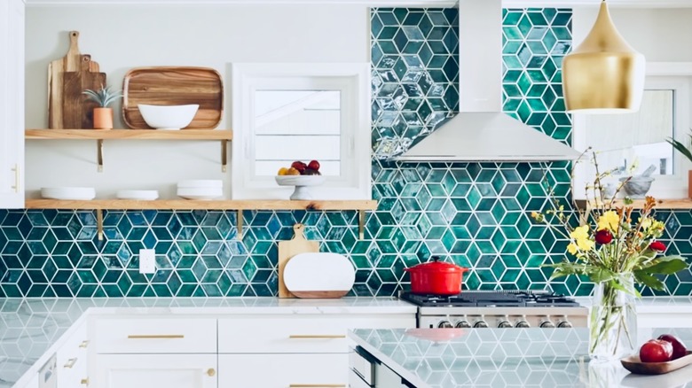 A vibrant red backsplash makes a statement in this kitchen.