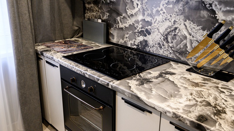 A richly patterned marble serves as both countertop and backsplash.
