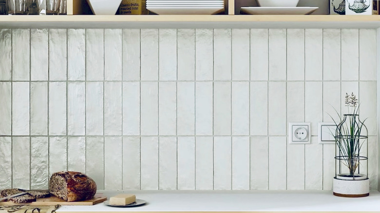 A textured zellige backsplash goes nicely with a smooth, white countertop.