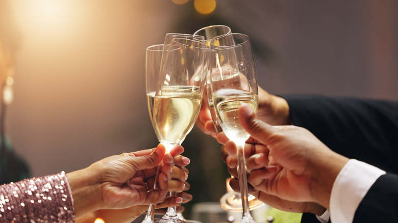 Close-up shot of friends toasting with Champagne glasses