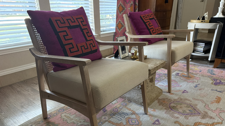 A twin set of oak-framed armchairs with deep, comfortable cushions