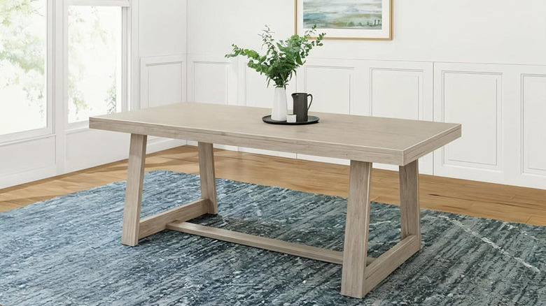 A product image of Plank & Beam's mid-century modern dining table in black