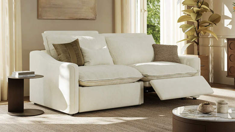 Povison's smart sofa in white sits in a living room beside some bright windows