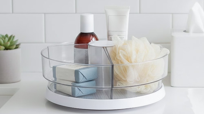 Mainstays' Clear Lazy Suzan Turntable loaded with bathroom supplies