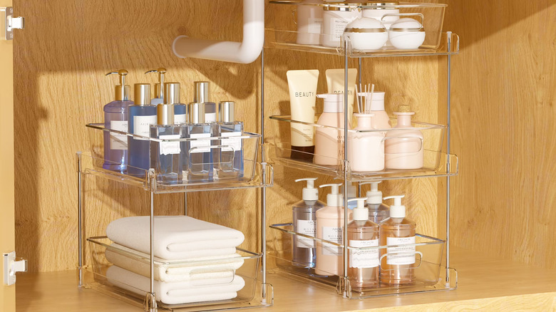 Sindcom's Plastic Bathroom Storage Organizer Set, loaded with toiletries and placed inside a bathroom vanity cabinet