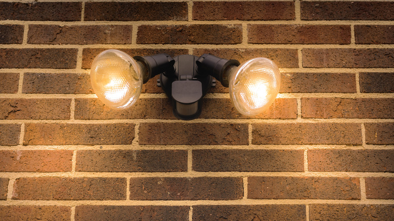 Flood lights on the exterior of a brick house