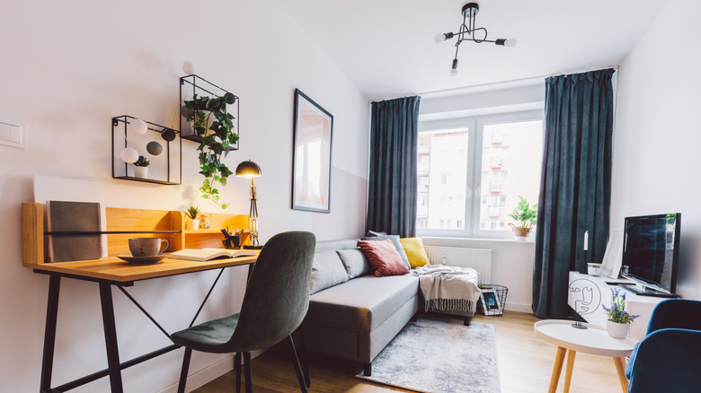 small apartment living room with work area