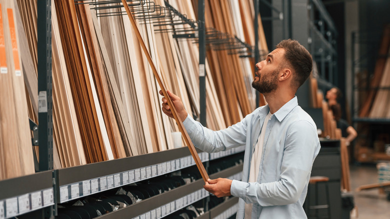 Man looking at different trim options at a home improvement store