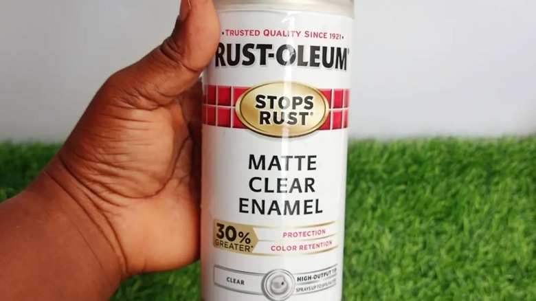 A person holding Rust-Oleum Matte Clear Enamel spray