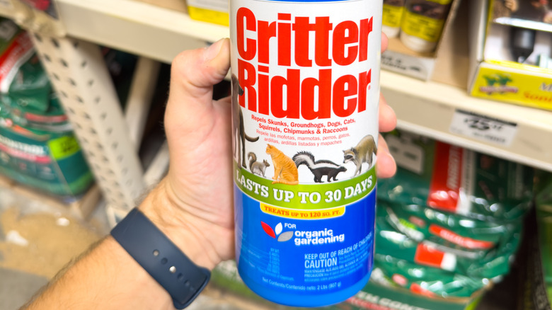 A person holding Critter Ridder pest repellent