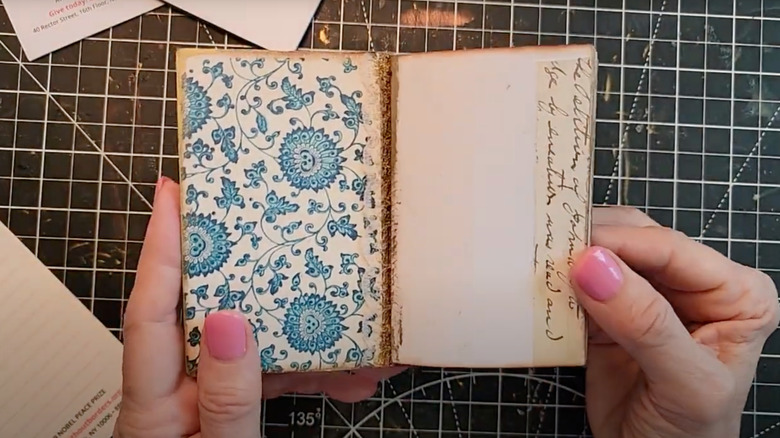 Woman holding small notebook