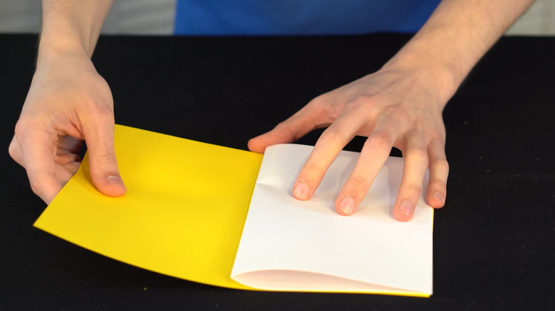 Person making diy paper book